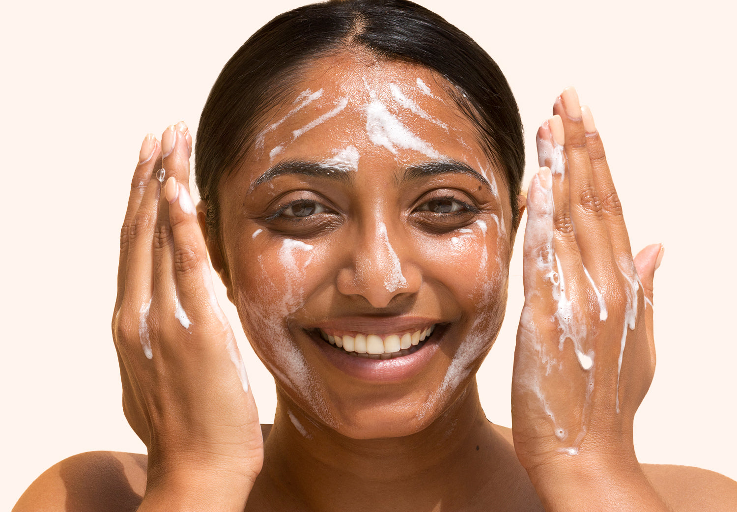 Image of woman washing her face with Plantkos face cleanser