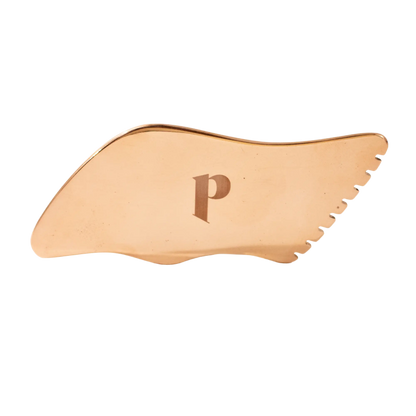 Copper gua sha tool with a letter 'P' on a white background
