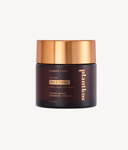 Jar of Plantkos face cream with gold lid on a white background